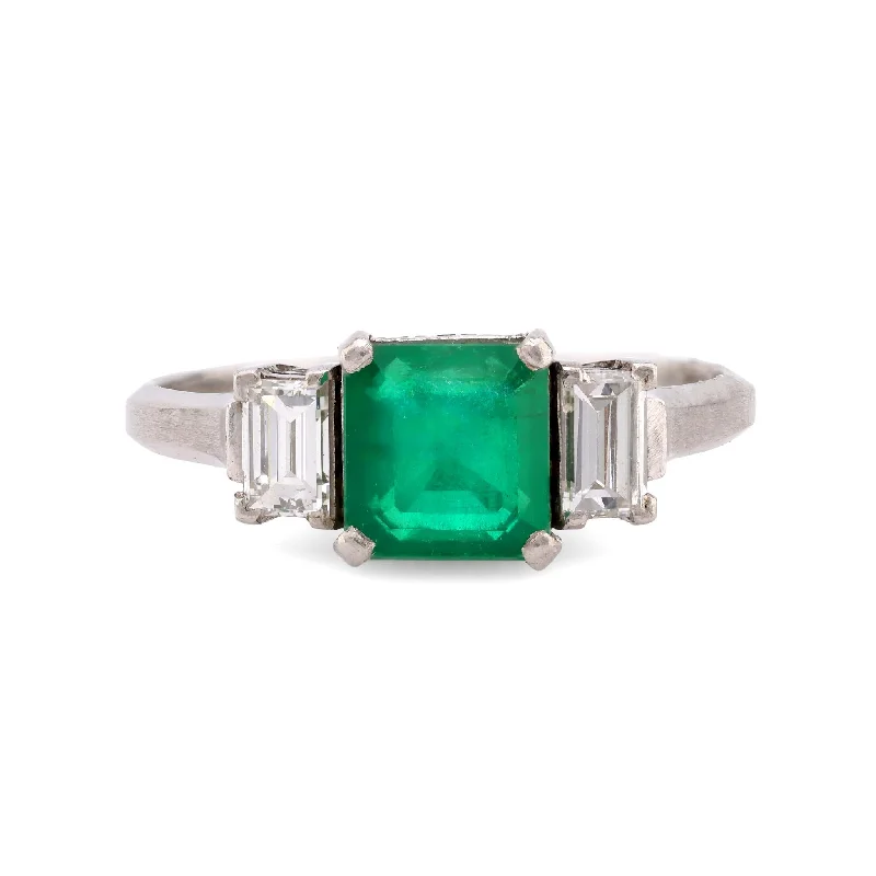 bold statement engagement ring -Timeless emerald diamond platinum three stone ring